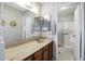 Bathroom featuring a marble countertop vanity, mirrors, and shower with glass doors at 12087 S Paiute St, Phoenix, AZ 85044