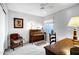 Bright bedroom with a comfortable chair and natural light, creating a cozy and inviting atmosphere at 12087 S Paiute St, Phoenix, AZ 85044