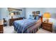 Cozy bedroom featuring a large window, side tables with lamps, and comfortable bed with warm colors at 12087 S Paiute St, Phoenix, AZ 85044