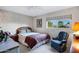 Comfortable bedroom with large window, providing natural light and a pleasant view of the outdoors at 12087 S Paiute St, Phoenix, AZ 85044