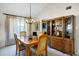 Elegant dining room with a wooden table set, chandelier, and built-in china cabinet at 12087 S Paiute St, Phoenix, AZ 85044