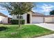 Inviting single-story home with well-maintained lawn, mature tree, and a two-car garage at 12087 S Paiute St, Phoenix, AZ 85044