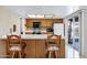Bright kitchen featuring a breakfast bar, classic cabinetry, and sliding glass doors to the backyard at 12087 S Paiute St, Phoenix, AZ 85044