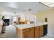 Kitchen offers backyard access, a breakfast bar, white countertops, and connects to a bonus room at 12087 S Paiute St, Phoenix, AZ 85044
