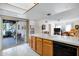 Kitchen offers backyard access, a breakfast bar, white countertops, and connects to a bonus room at 12087 S Paiute St, Phoenix, AZ 85044