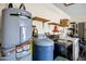 Laundry room showcasing a water heater, softener and newer washer and dryer at 12087 S Paiute St, Phoenix, AZ 85044