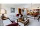 Cozy living room offering comfortable seating, a vintage-style bookcase, and access to the dining area at 12087 S Paiute St, Phoenix, AZ 85044