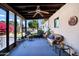 Enclosed screened porch with ceiling fan and comfortable seating with view of backyard at 12087 S Paiute St, Phoenix, AZ 85044
