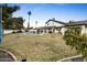Spacious backyard with a sparkling pool, grassy area, and mountain views at 13026 N 12Th Ave, Phoenix, AZ 85029