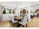 Elegant dining area with a farmhouse table and views into the kitchen at 13026 N 12Th Ave, Phoenix, AZ 85029