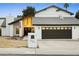 Modern two-story house with dark brown garage doors and a manicured lawn at 13026 N 12Th Ave, Phoenix, AZ 85029