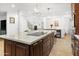 Spacious kitchen island with seating and a sleek cooktop at 13026 N 12Th Ave, Phoenix, AZ 85029