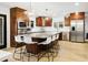 Modern kitchen with a large island, stainless steel appliances, and dark wood cabinets at 13026 N 12Th Ave, Phoenix, AZ 85029