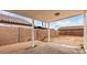 Desert landscaped backyard with a covered patio and privacy fence at 14915 W Port Royale Ln, Surprise, AZ 85379