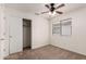 Cozy bedroom with plush carpeting, neutral walls, closet space, and a window letting in natural light at 14915 W Port Royale Ln, Surprise, AZ 85379