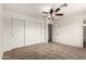 A spacious bedroom with carpeted floors, a large closet, and an attached bathroom at 14915 W Port Royale Ln, Surprise, AZ 85379