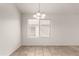 Dining area featuring tile flooring, neutral walls, a chandelier and a window providing natural light at 14915 W Port Royale Ln, Surprise, AZ 85379