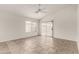 Bright living area featuring tile flooring, neutral walls, a ceiling fan, a window and sliding glass doors at 14915 W Port Royale Ln, Surprise, AZ 85379