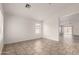 Spacious living area with tile flooring, neutral walls, and a view of the backyard through sliding glass doors at 14915 W Port Royale Ln, Surprise, AZ 85379