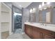 Modern bathroom with double vanity, updated shower, and gray walls at 14949 W Robson Cir, Goodyear, AZ 85395