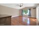 Hardwood floor Gathering room with sliding glass doors and pool view at 14949 W Robson Cir, Goodyear, AZ 85395