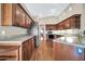 Eat-in kitchen with stainless steel appliances and hardwood floors at 14949 W Robson Cir, Goodyear, AZ 85395
