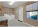 Bright laundry room features washer, dryer, and ample shelving at 14949 W Robson Cir, Goodyear, AZ 85395