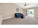 Living room with a navy couch and access to the pool area at 14949 W Robson Cir, Goodyear, AZ 85395