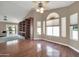 Bright living room featuring hardwood floors and built-in shelving at 14949 W Robson Cir, Goodyear, AZ 85395