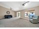 Living room with dark blue sofa and access to backyard at 14949 W Robson Cir, Goodyear, AZ 85395