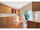 Home office with wood built-ins and hardwood floors at 14949 W Robson Cir, Goodyear, AZ 85395