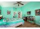 Guest bedroom with ceiling fan and teal walls at 17198 N Willow Path, Surprise, AZ 85374