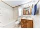 Bathroom with tub, toilet, and wood vanity at 17200 W Bell Rd # 1581, Surprise, AZ 85374