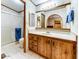 Clean bathroom with wood cabinets and a shower at 17200 W Bell Rd # 1581, Surprise, AZ 85374