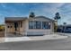 Single-wide manufactured home with carport and street view at 17200 W Bell Rd # 1581, Surprise, AZ 85374