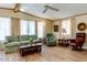 Spacious living room with light wood floors, comfy seating, and large windows at 17200 W Bell Rd # 1581, Surprise, AZ 85374