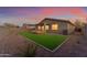 Spacious backyard featuring artificial turf and a covered patio at 17574 W Cardinal Dr, Goodyear, AZ 85338