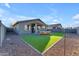Spacious backyard with artificial turf and patio at 17574 W Cardinal Dr, Goodyear, AZ 85338