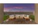 Relaxing backyard patio with sectional sofa and coffee table, perfect for outdoor entertaining at 17574 W Cardinal Dr, Goodyear, AZ 85338