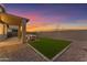 Artificial turf backyard with a covered patio and seating area at 17574 W Cardinal Dr, Goodyear, AZ 85338