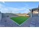 Spacious backyard with artificial turf and patio at 17574 W Cardinal Dr, Goodyear, AZ 85338