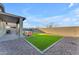 Artificial turf backyard with covered patio and seating area at 17574 W Cardinal Dr, Goodyear, AZ 85338