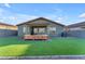 Spacious backyard with artificial turf and patio at 17574 W Cardinal Dr, Goodyear, AZ 85338