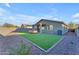 Artificial turf backyard with patio and seating area at 17574 W Cardinal Dr, Goodyear, AZ 85338