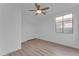 Well-lit bedroom with ceiling fan, sliding door closet, and window at 17574 W Cardinal Dr, Goodyear, AZ 85338