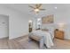 Main bedroom with ensuite bathroom access and a ceiling fan at 17574 W Cardinal Dr, Goodyear, AZ 85338