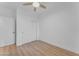 Bright bedroom with ceiling fan, sliding door closet, and light wood floors at 17574 W Cardinal Dr, Goodyear, AZ 85338