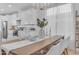 Bright dining area with a wood table and white chairs, adjacent to kitchen at 17574 W Cardinal Dr, Goodyear, AZ 85338