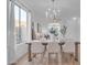 Bright dining room with a large table and modern chandelier at 17574 W Cardinal Dr, Goodyear, AZ 85338