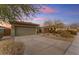 House exterior showcasing a two-car garage and well-maintained landscaping at 17574 W Cardinal Dr, Goodyear, AZ 85338